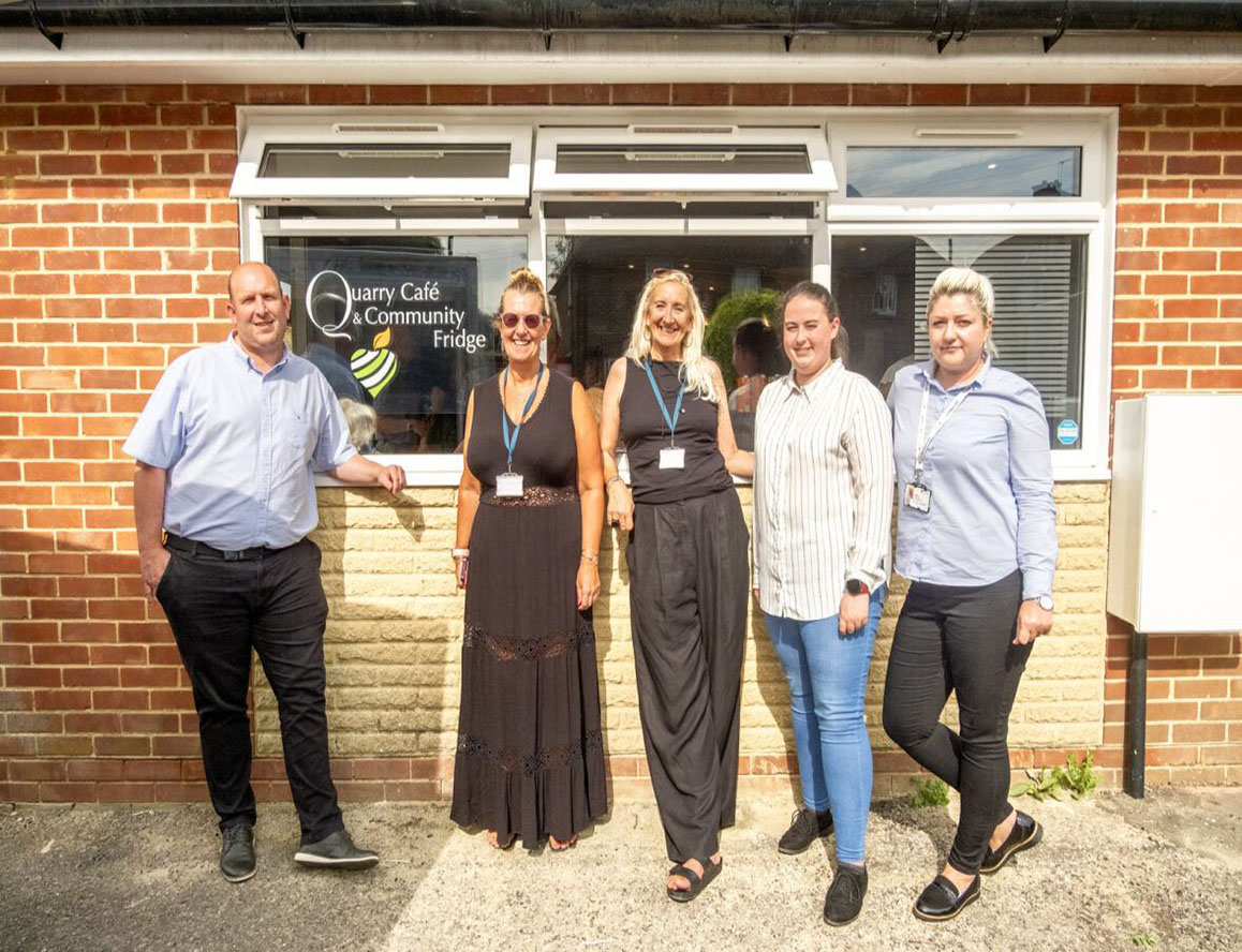 group standing in front of community cafe