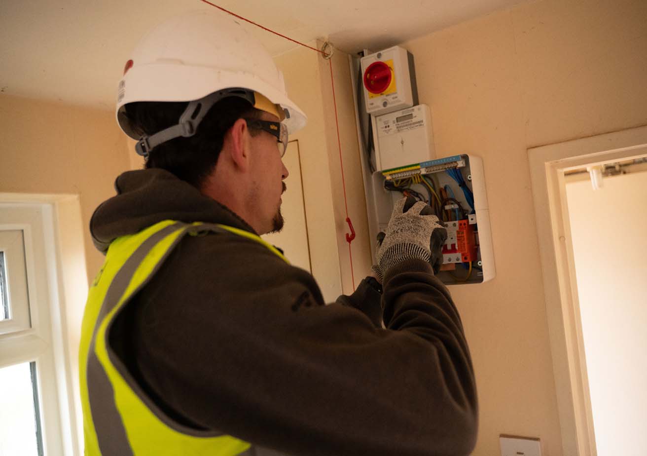 employee carrying out electrical works in home
