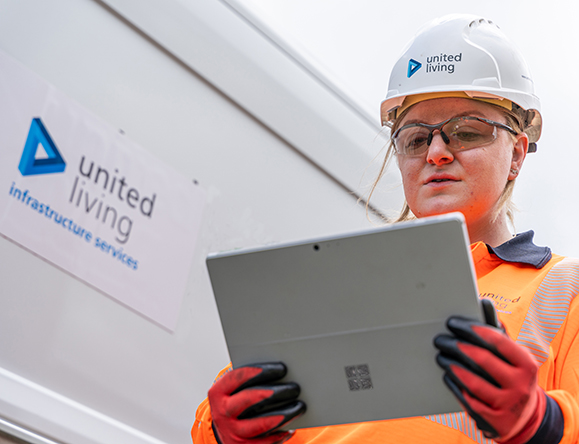 female construction operative holding tablet