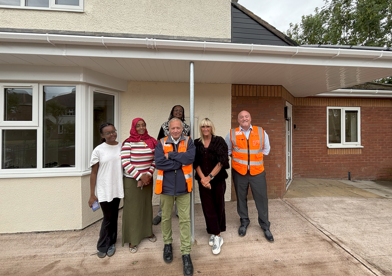EMPLOYEES AND RESIDENTS STANDING OUTSIDE OF HOME