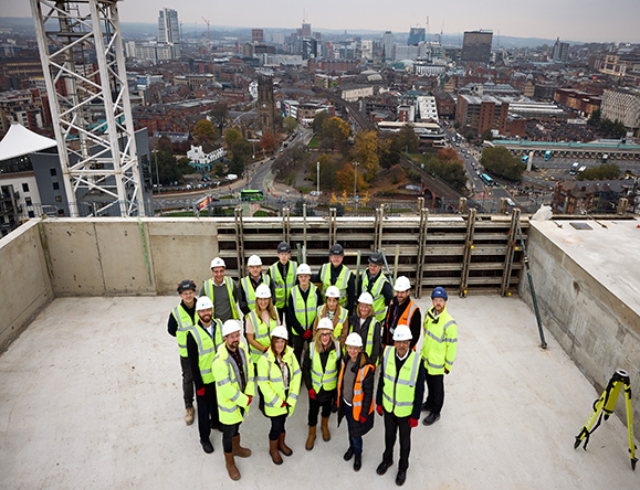 construction workers celebrating topping out ceremony of new build development