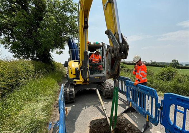 excavator working on country road