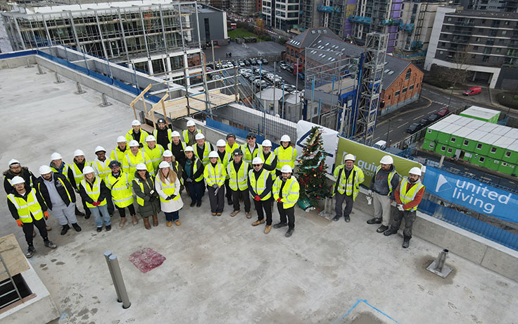 group celebrate topping out ceremony of residential building