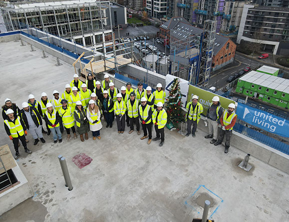 group celebrate topping out ceremony of residential building