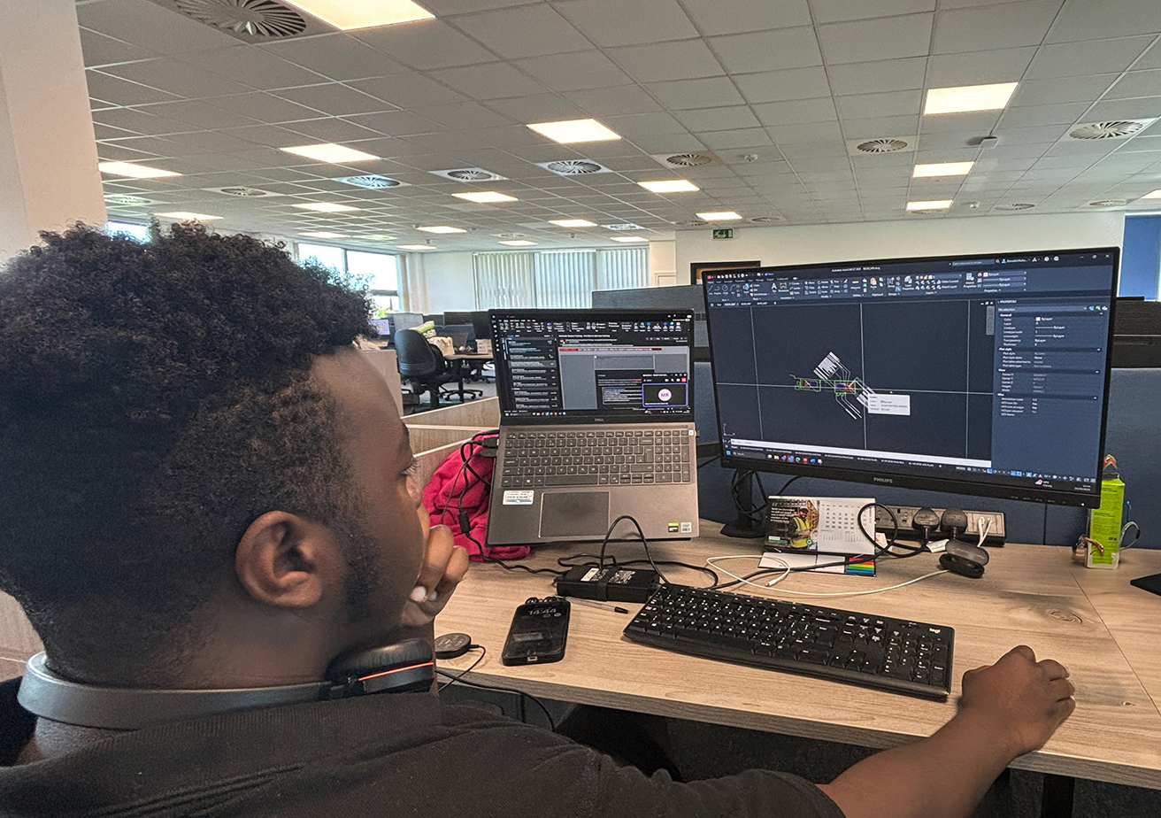 employee at desk working on software