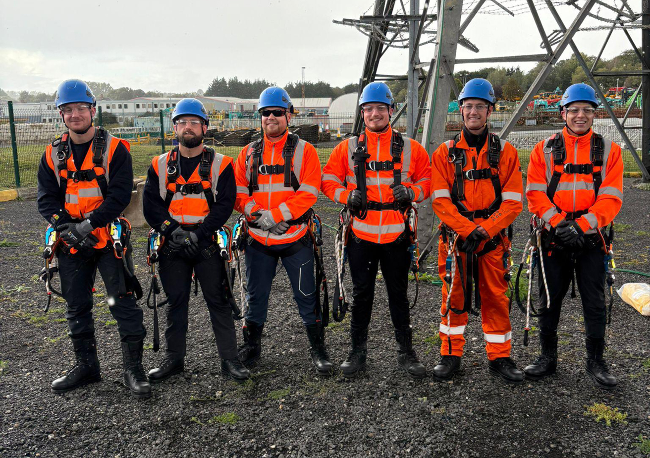 power team standing in front of pylon