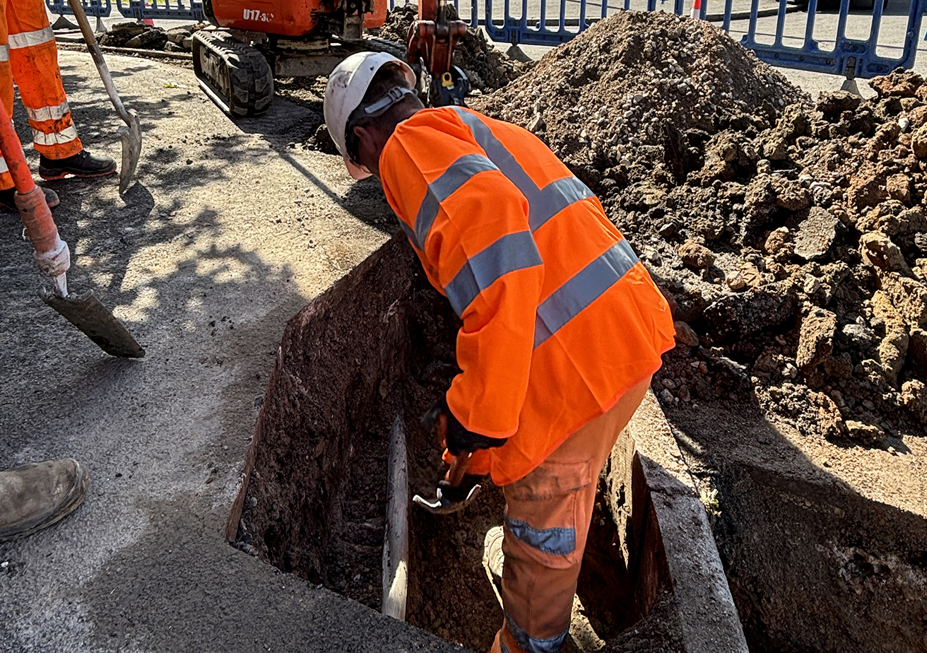 digger on construction site with construction worker
