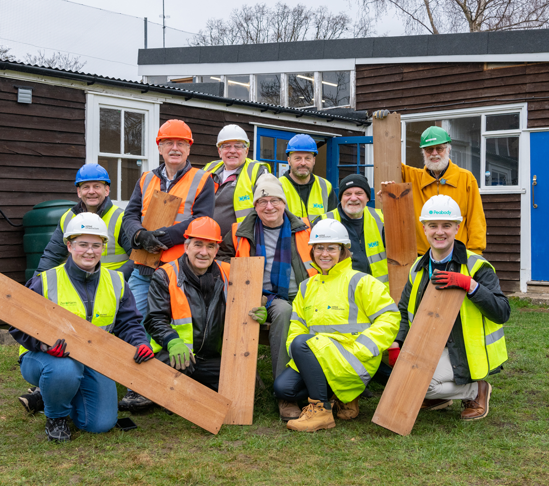 group of united infrastructure employees donating to sustainable charity
