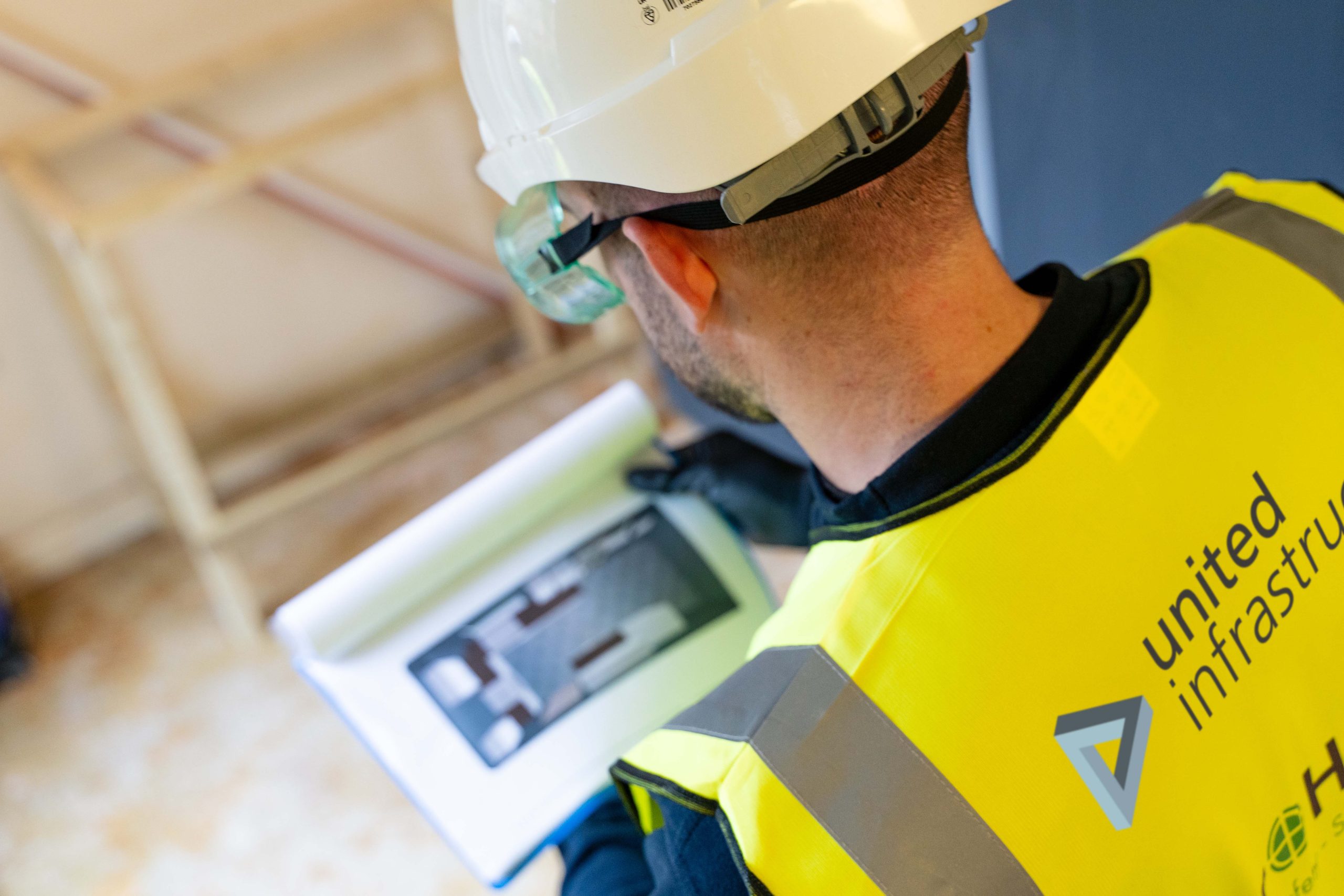 united infrastructure employee reading notes