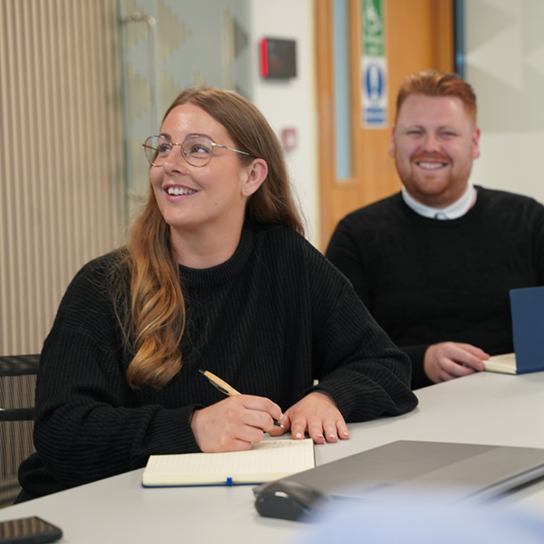 two employees sat at desk