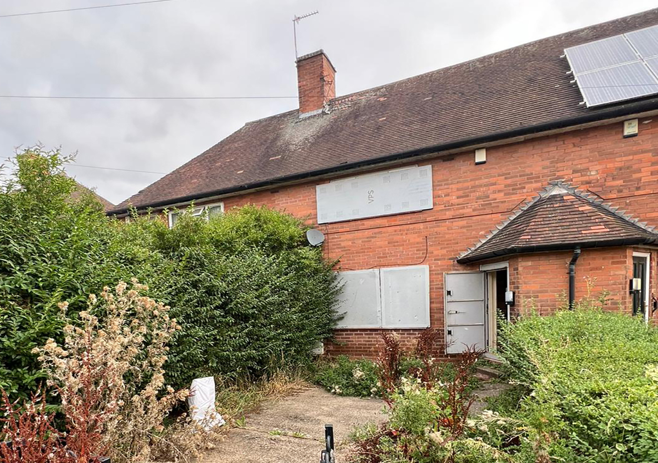 Empty property with boarded windows